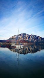 Sailboat in lake against sky