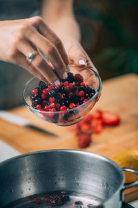 Fruit canning preservation. woman cooking fruits and making homemade jam.