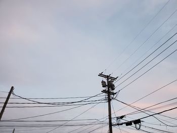 Low angle view of electricity pylon against sky