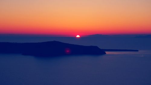 Scenic view of sea against romantic sky at sunset