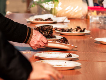 Midsection of people preparing food