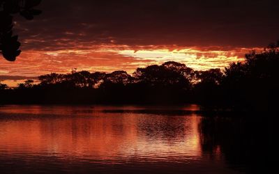 Scenic view of lake against romantic sky at sunset