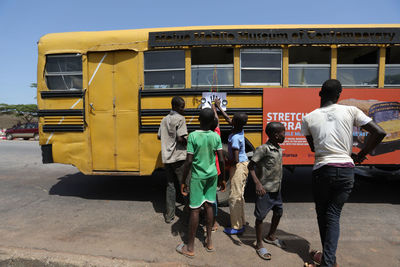 Rear view of people on street in city