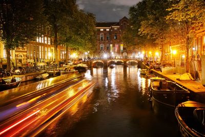 View of canal in city at night