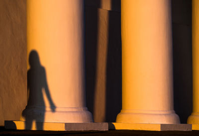 Shadow of woman on architectural column