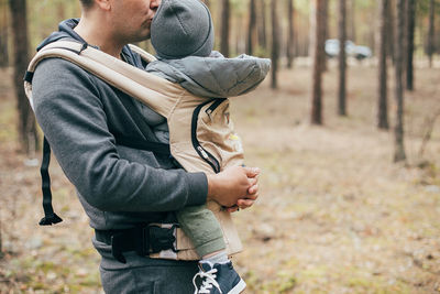 Father and son standing on land