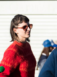 Woman wearing sunglasses and warm clothing outdoors