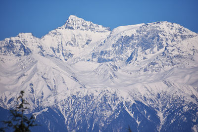 Scenic view of snowcapped mountains against clear sky