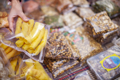 Close-up of hand holding ice cream for sale