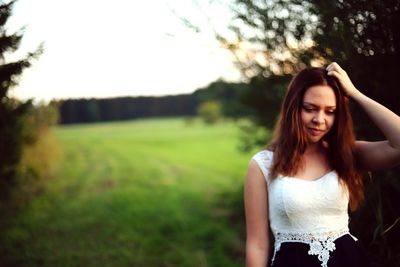 Beautiful young woman standing on a land
