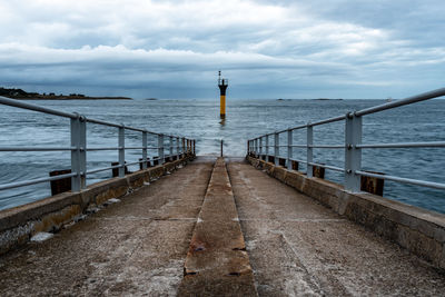 Jetty to ferry to ile de batz in the harbour of roscoff, brittany. view at sunset