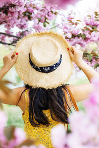 Rear view of woman wearing summer hat