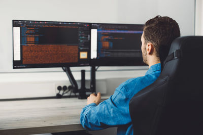 Rear view of man working at home