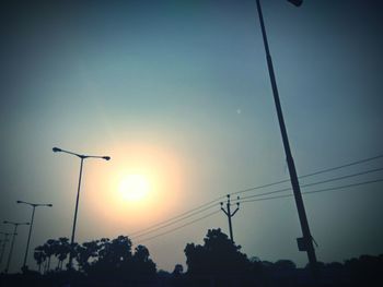 Low angle view of silhouette street light against sky during sunset