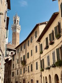 Low angle view of buildings against blue sky