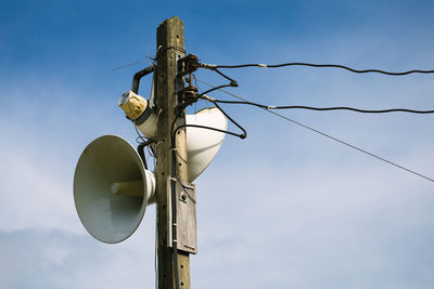 Low angle view of megaphones against sky