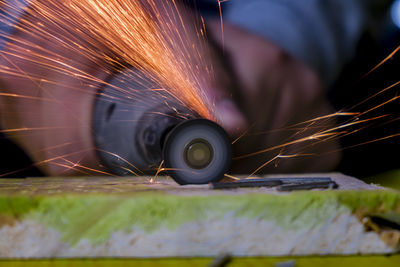 Craftsperson cutting wood from electric saw