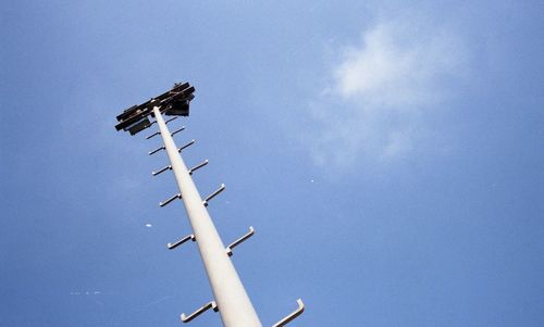 Low angle view of windmill against blue sky