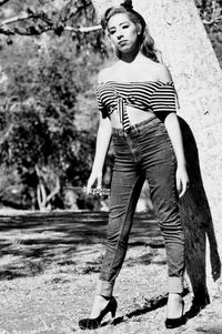 Full length of young woman standing on ground