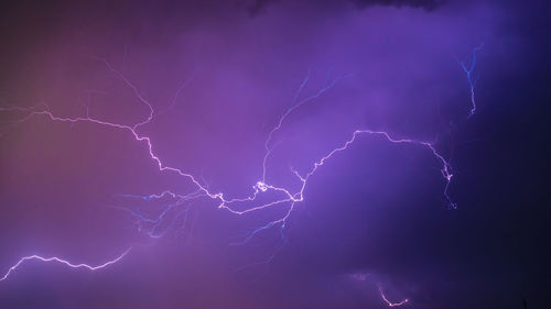 Low angle view of lightning in sky at night