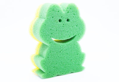 Close-up of green toy against white background