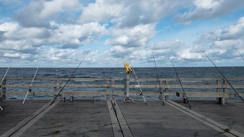 Scenic view of beach fishing against sky