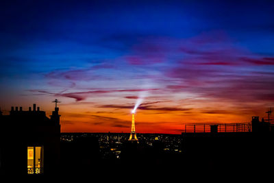 Silhouette buildings against sky at night