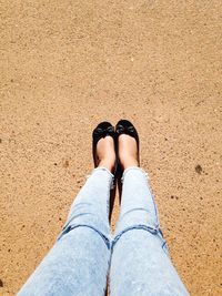 Low section of woman wearing black flat shoe