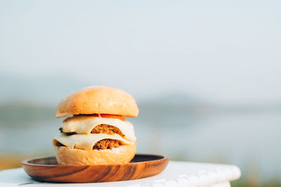 Close-up of bread in container on table against sea