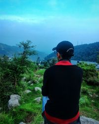 Rear view of man standing against sky