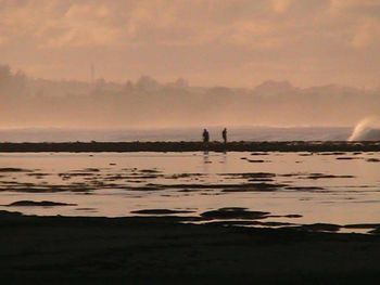 Silhouette of people at sunset