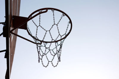 Low angle view of basketball hoop against clear sky