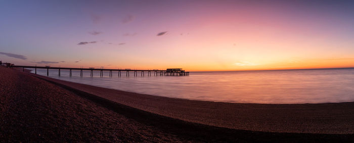 Scenic view of sea against romantic sky at sunset