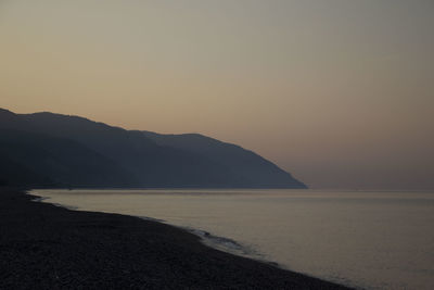 Scenic view of sea against clear sky during sunset