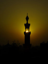 Silhouette of statue at sunset