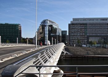 Bridge leading towards buildings in city