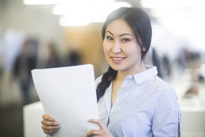 Young asia woman with paper in an office friendly