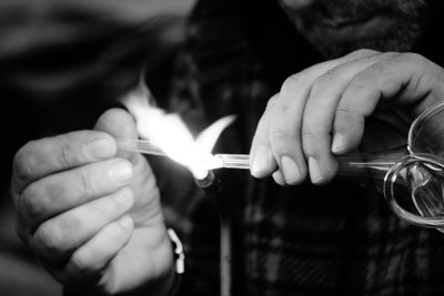 Close-up of hand holding cigarette