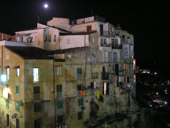 Illuminated city against sky at night