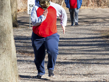 Low section of people walking on road