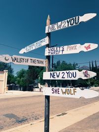 Road sign against sky