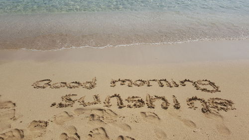 High angle view of text on beach