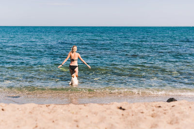 Full length of man on beach against sky