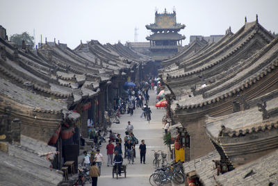 Panoramic view of people in town against clear sky