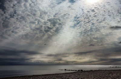 Scenic view of sea against storm clouds