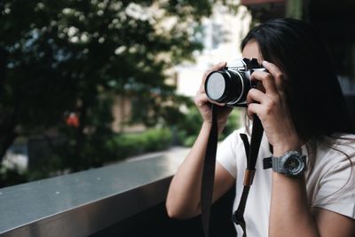 Portrait of woman photographing