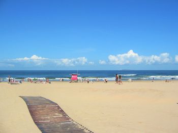 View of people on beach against sky