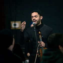 Man singing in darkroom during event