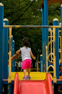 Rear view of girl playing in park