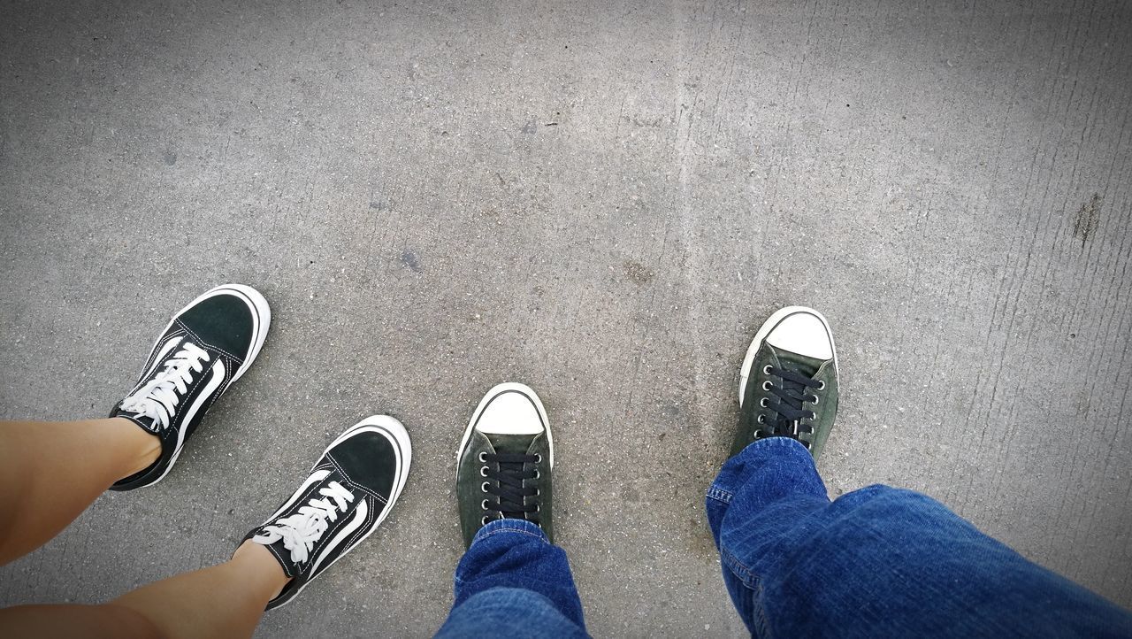 LOW SECTION OF MAN STANDING BY SHOES